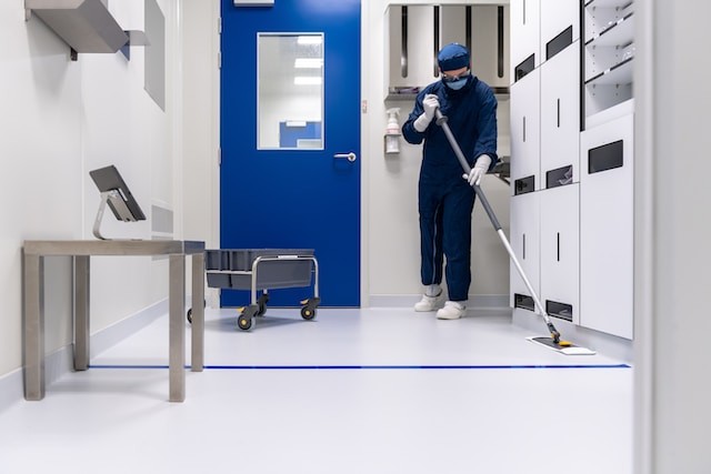 person from cleaning service clean the room