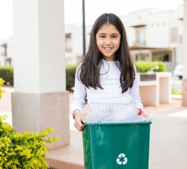 person holding trash can
