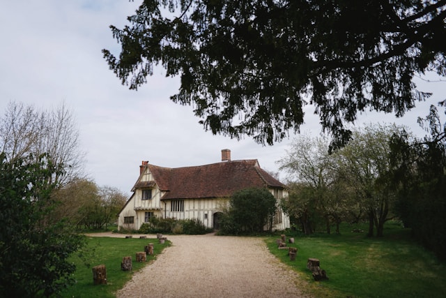 brown-and-white-house-near-green-trees-during-daytime