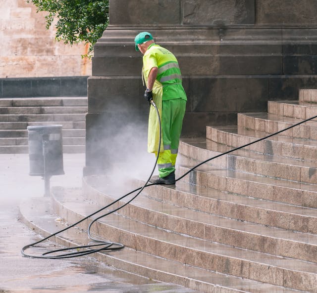 man-cleaning-stairs-on-street