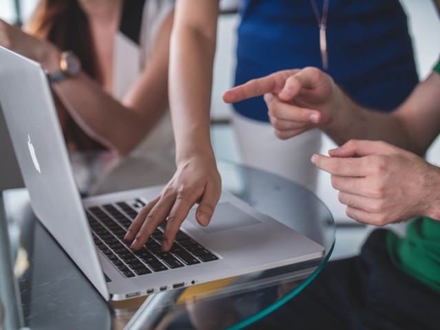 person-touching-and-pointing-macbook-pro