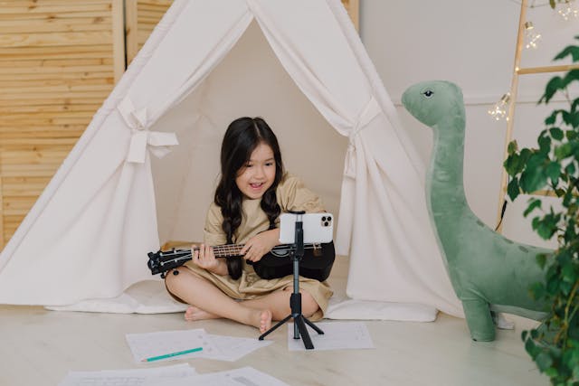 a-cute-girl-recording-a-video-while-playing-ukulele
