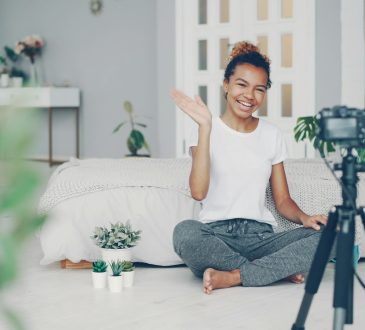 young-woman-waves-at-camera-in-a-room