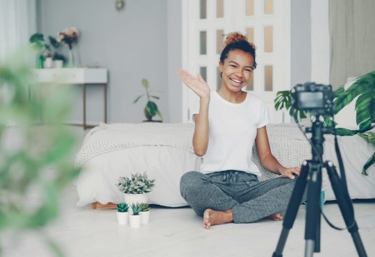 young-woman-waves-at-camera-in-a-room