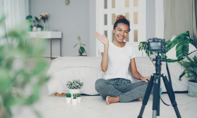 young-woman-waves-at-camera-in-a-room